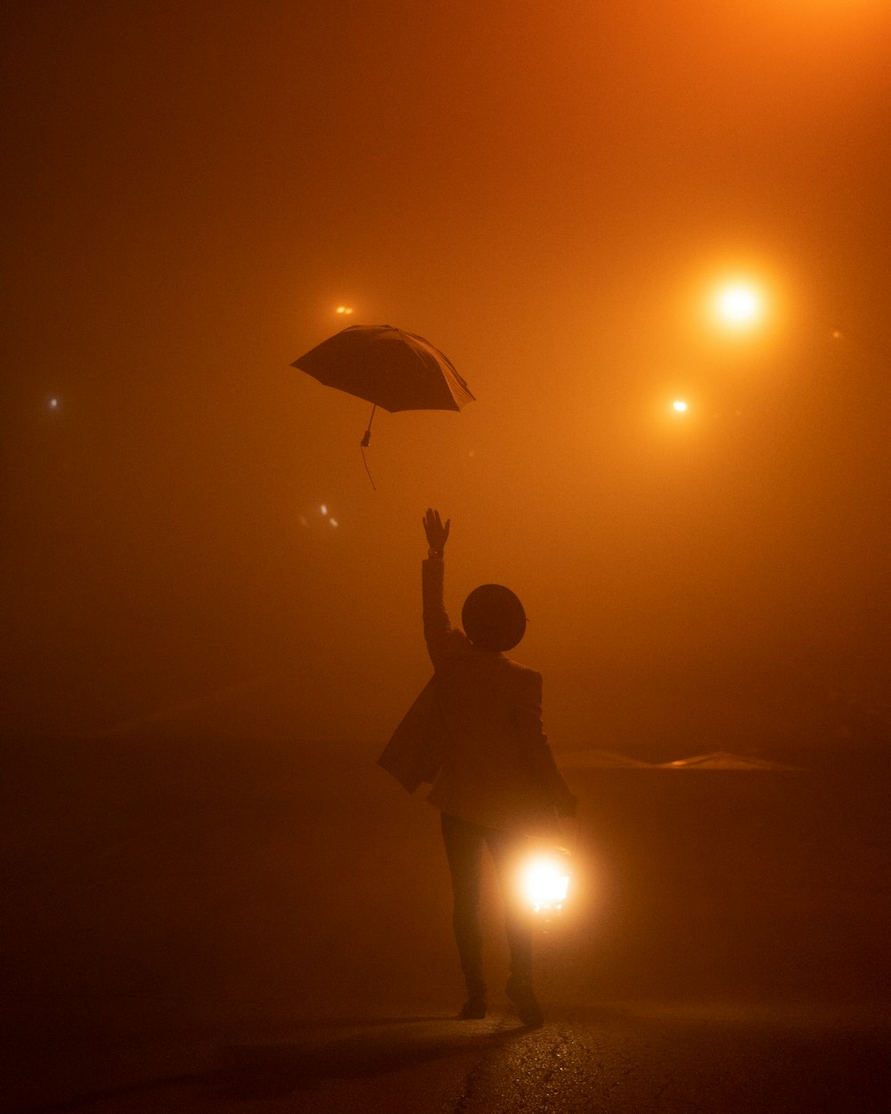 a person is flying a kite in the fog