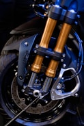 Set of shiny motorcycle brake discs and suspension springs displayed neatly