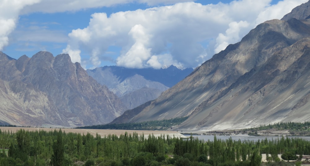 a mountain range with a river in the foreground