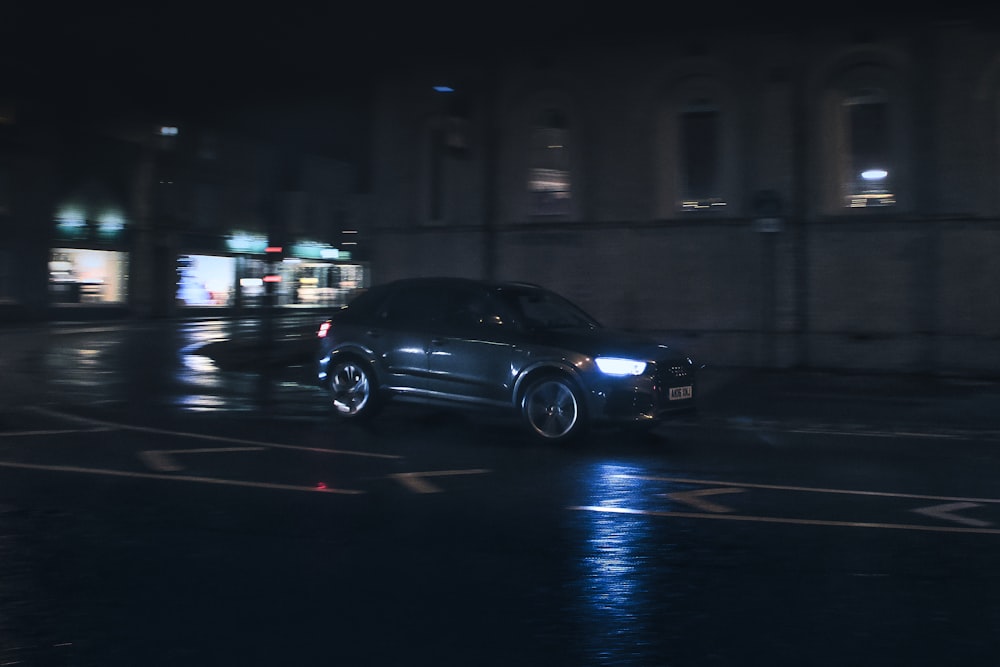 a car driving down a street at night