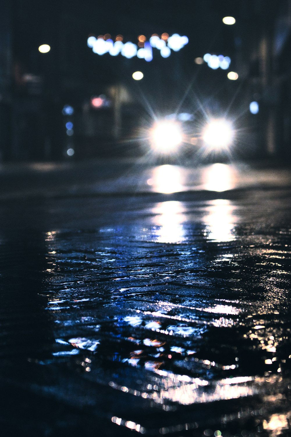 a car driving down a street at night