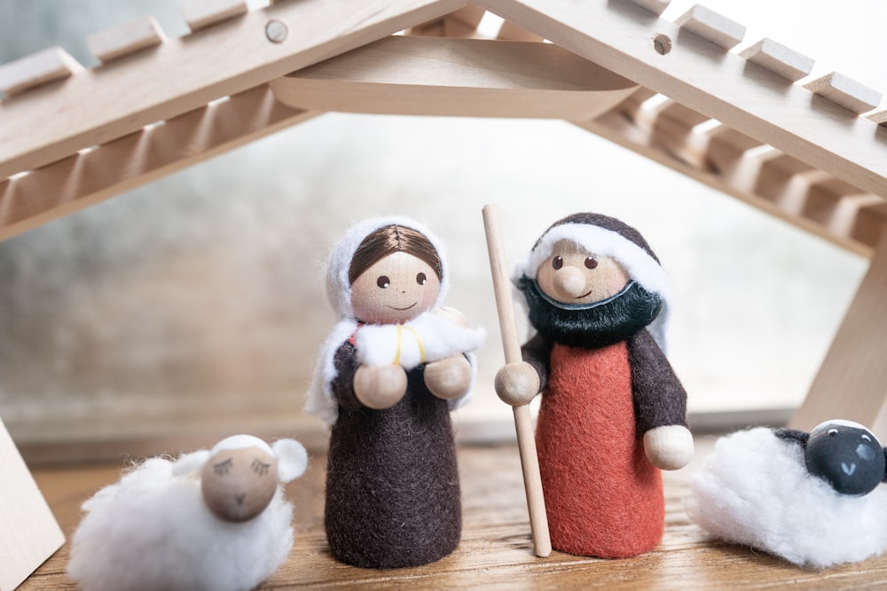 a nativity scene of a woman and two sheep