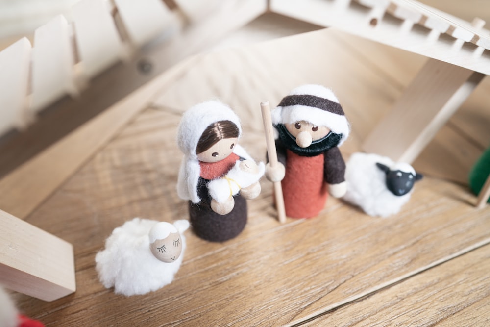 a group of toy figurines sitting on top of a wooden floor