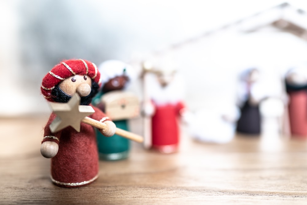 a wooden figurine holding a star on a table