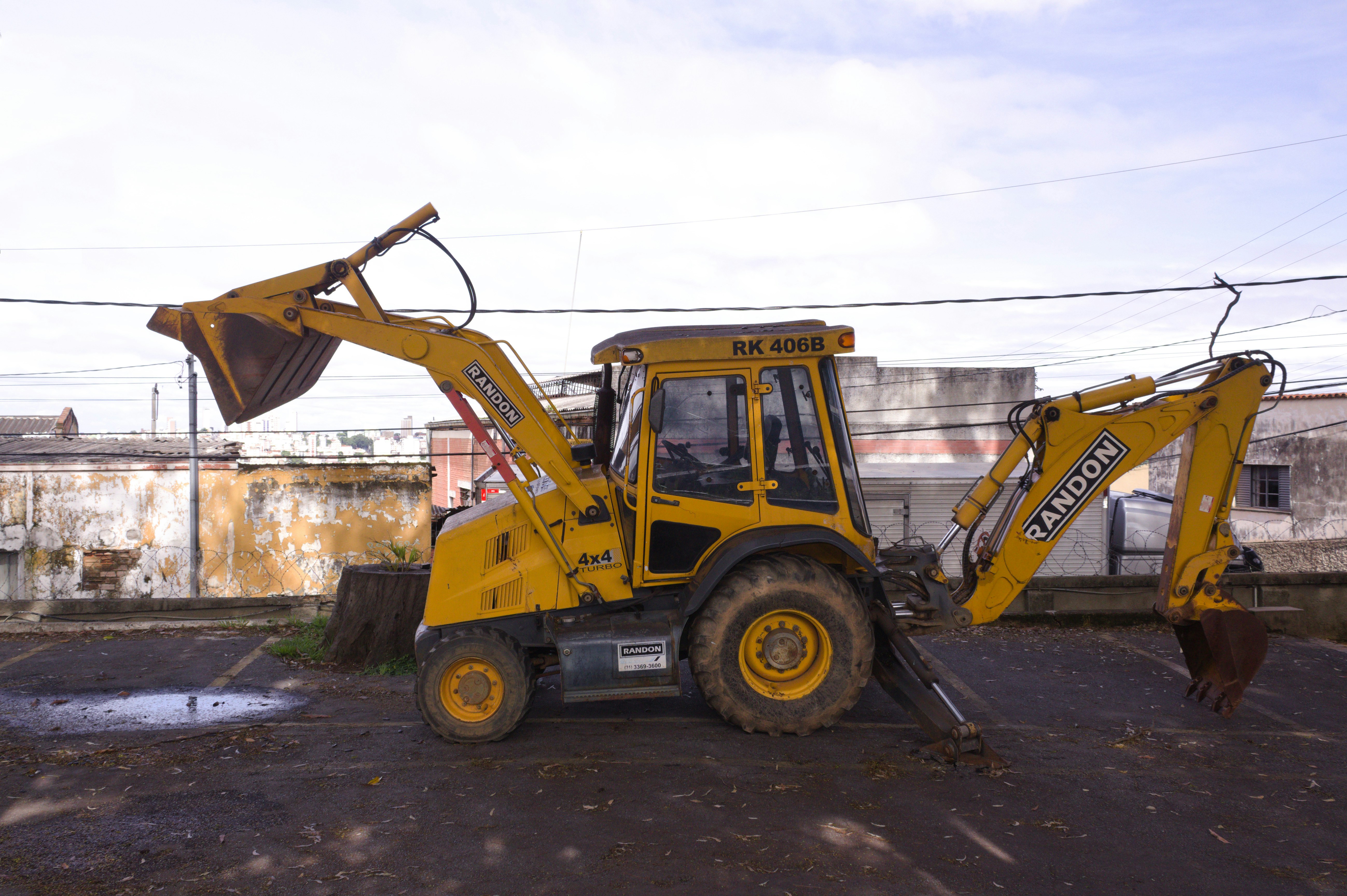 a yellow bulldozer parked in a parking lot