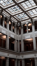 a large building with a glass ceiling and a clock on the wall
