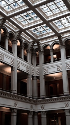 a large building with a glass ceiling and a clock on the wall
