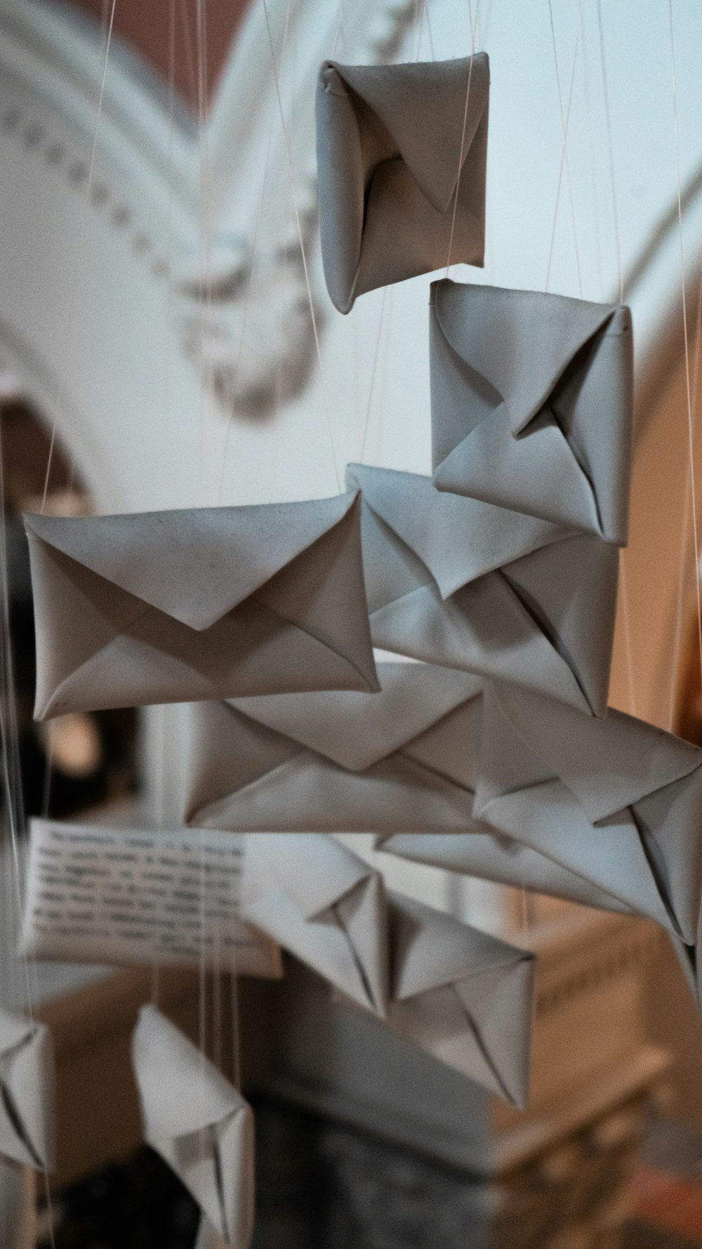 a close up of a paper sculpture hanging from a ceiling