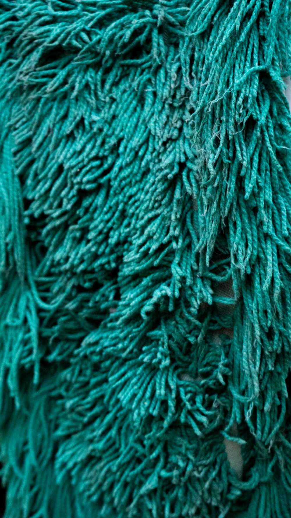 a close up of a person wearing a green coat