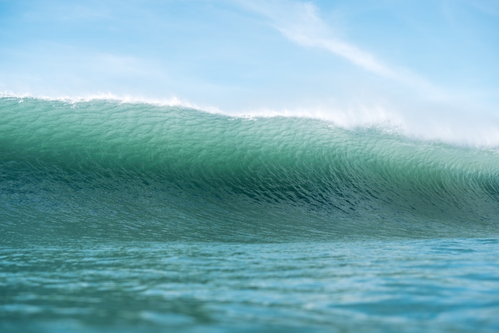 a large wave in the middle of the ocean