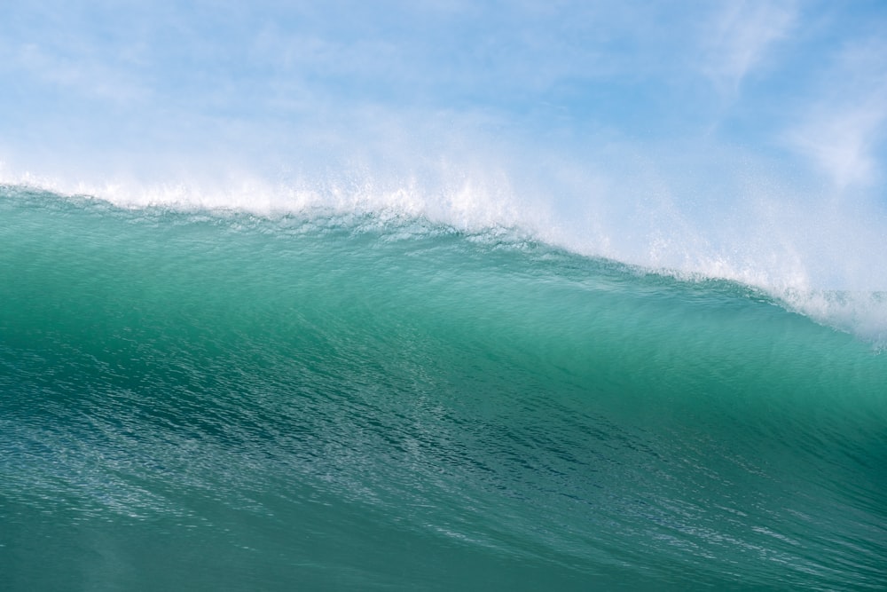 a man riding a wave on top of a surfboard