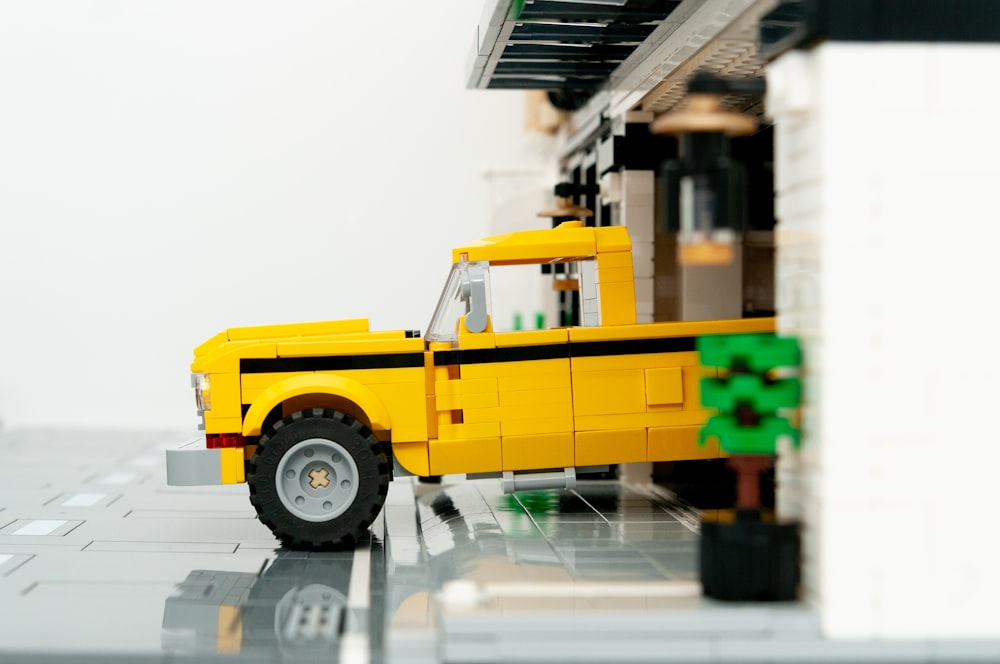 a yellow truck is parked in front of a building