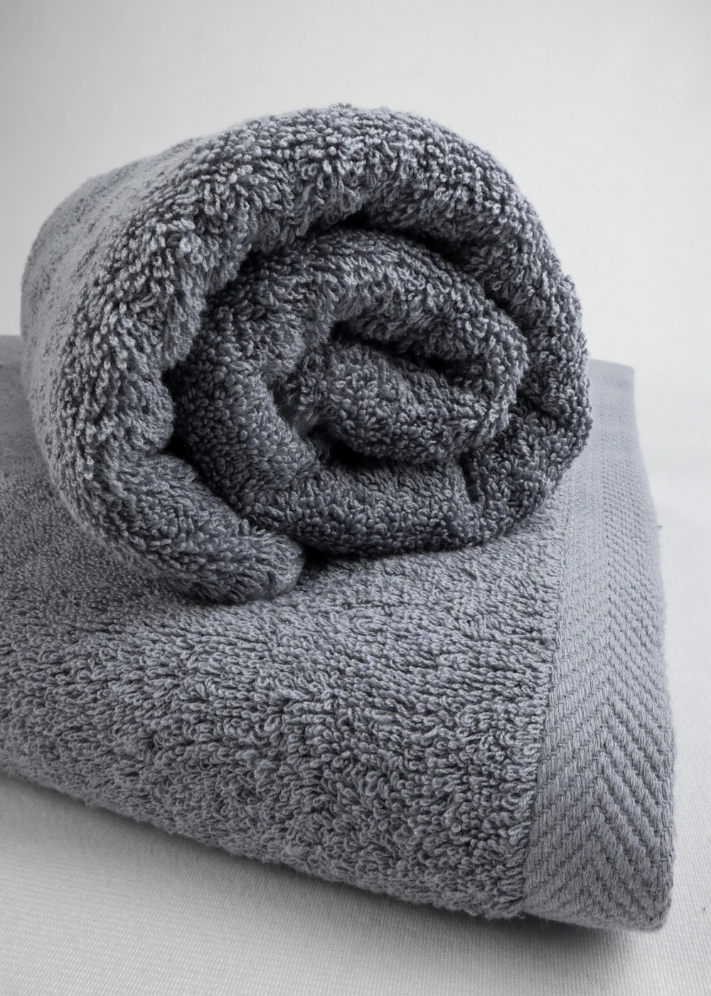 a folded textile on top of a bed