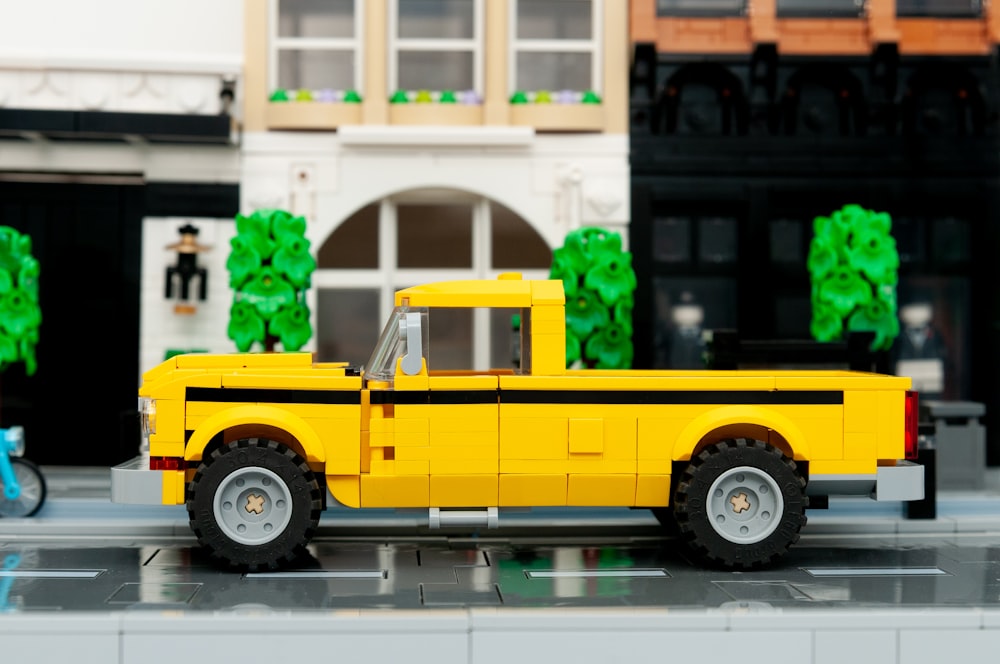 a yellow truck is parked in front of a building