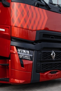 a close up of the front of a red truck