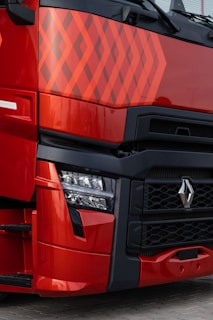 a close up of the front of a red truck