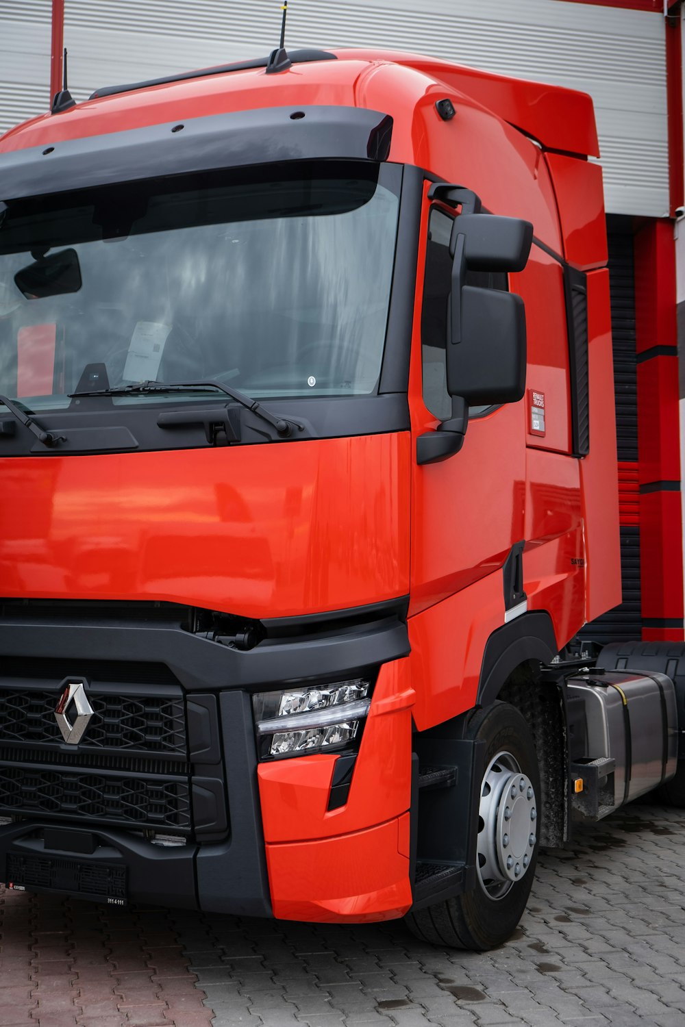 a red truck parked in front of a building