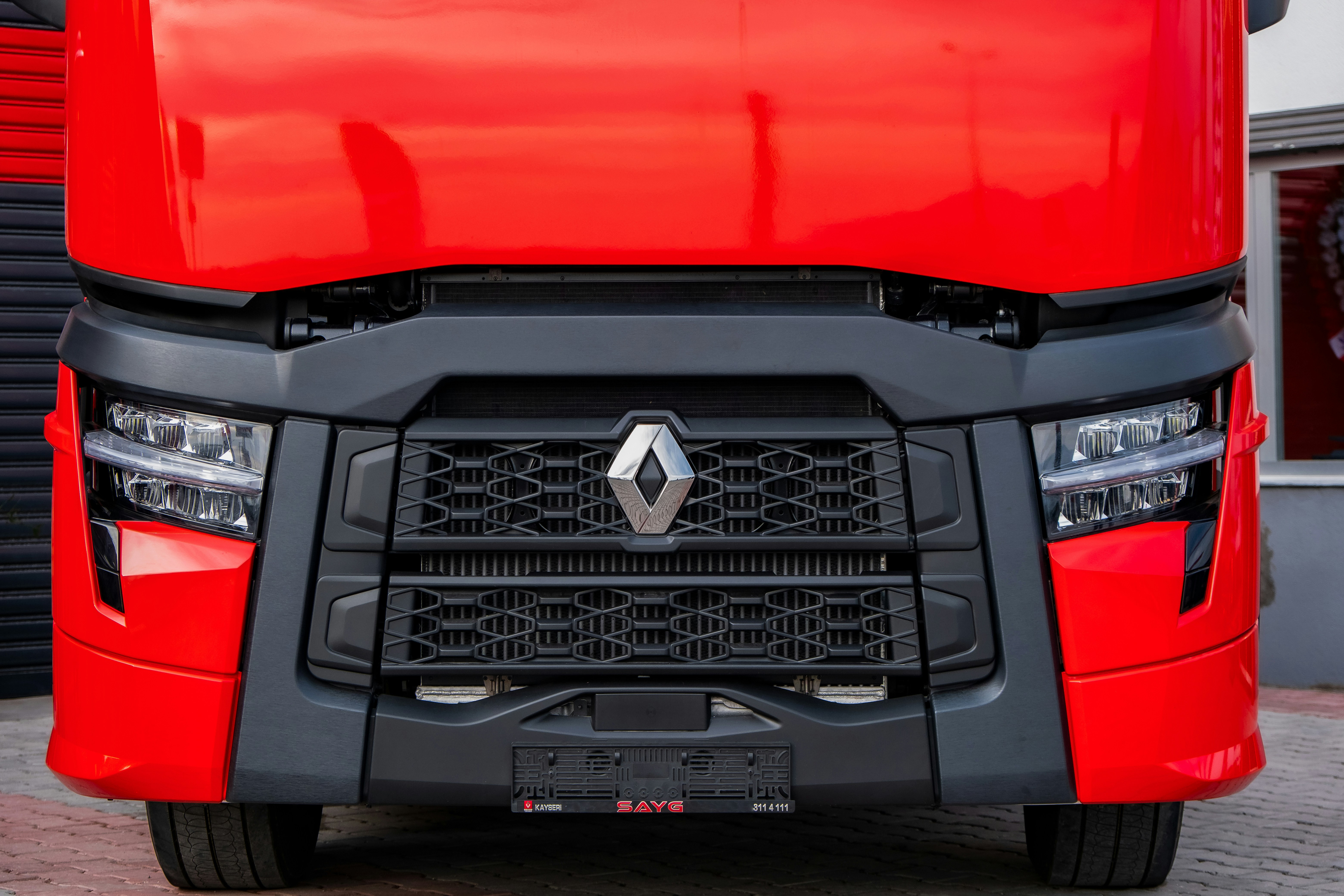 a close up of the front of a red truck
