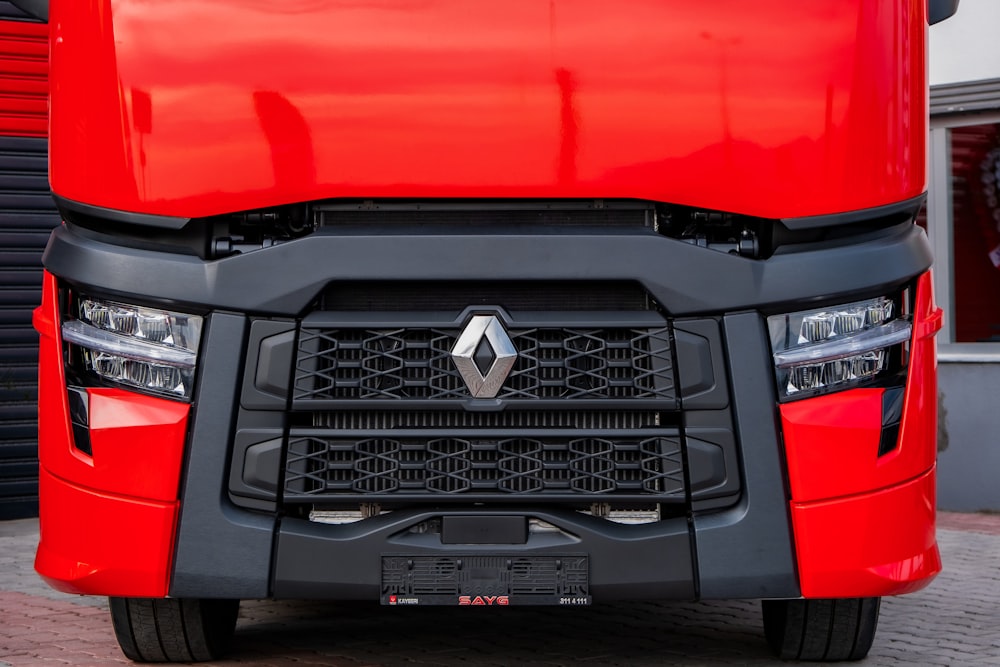 a close up of the front of a red truck