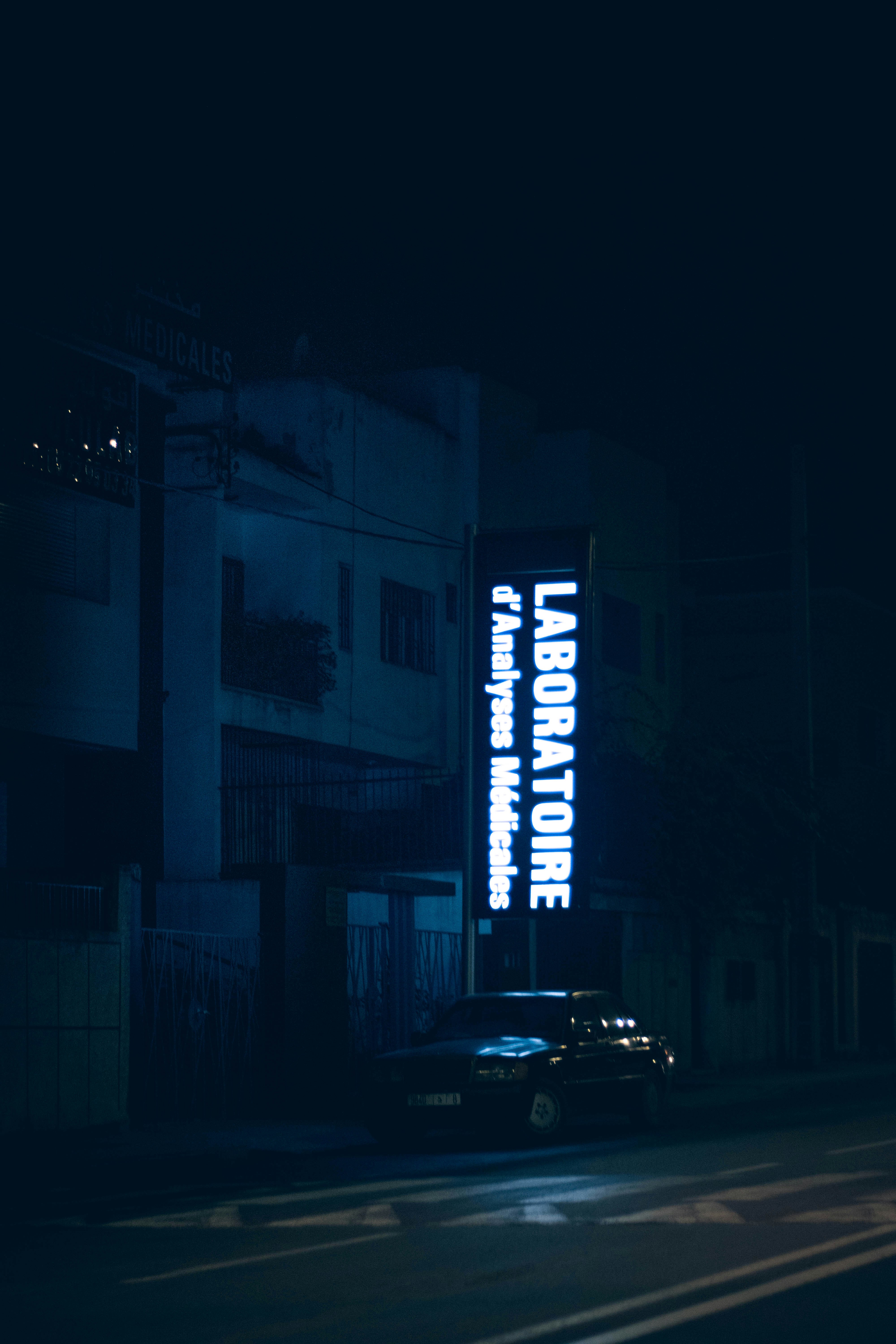 a car parked on the side of a road at night
