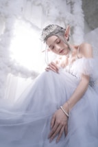 a woman in a white dress with a tiara