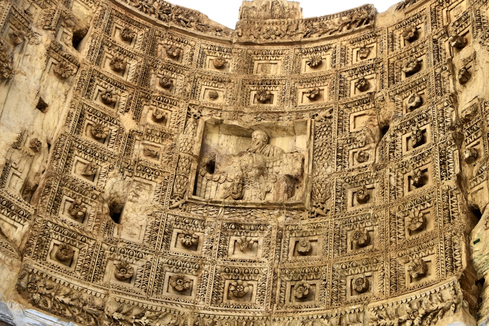 a close up of a stone structure with carvings on it