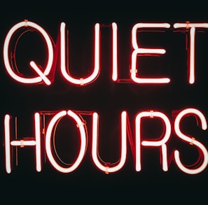 a neon sign that says quiet hours