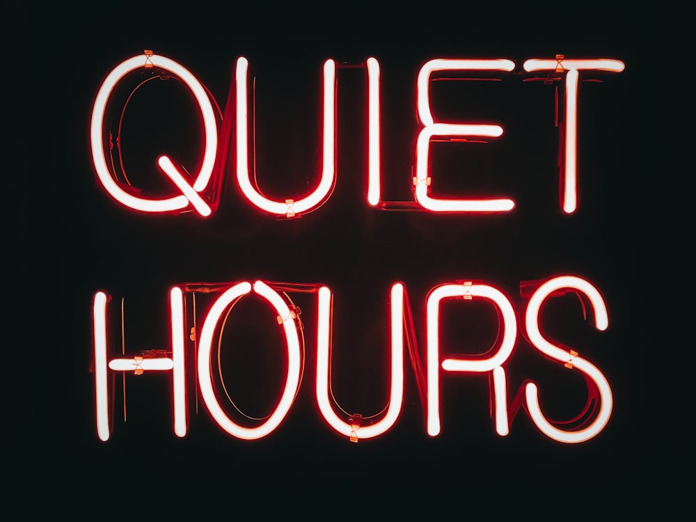 a neon sign that says quiet hours