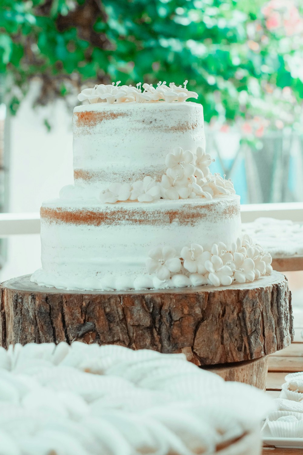 a three layer cake sitting on top of a wooden table