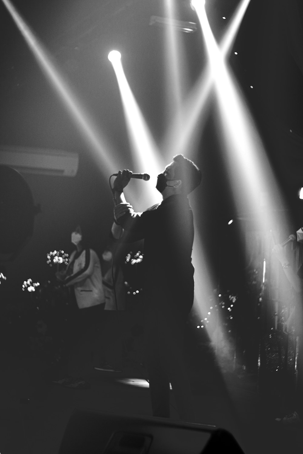 a man standing on a stage holding a microphone