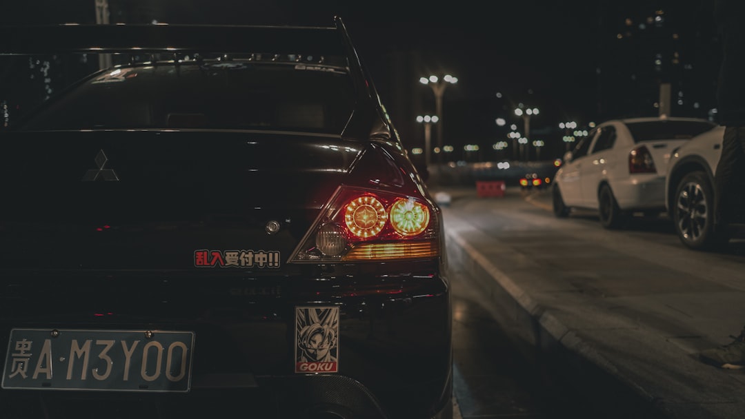 a car parked on the side of the road at night, lancer evolution