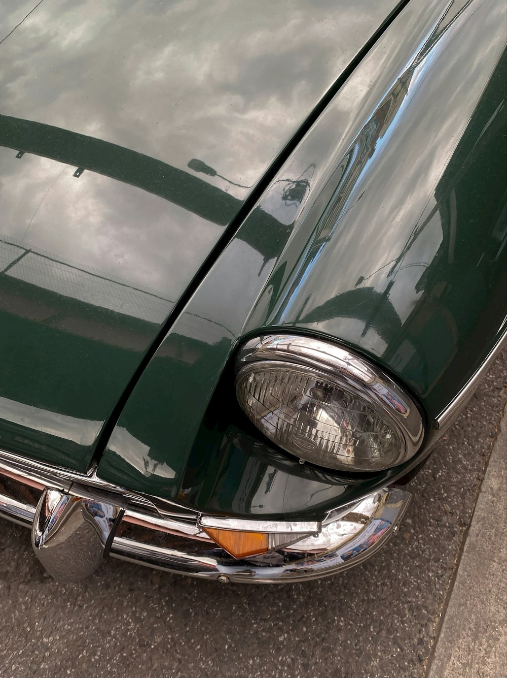 a close up of the front end of a green car