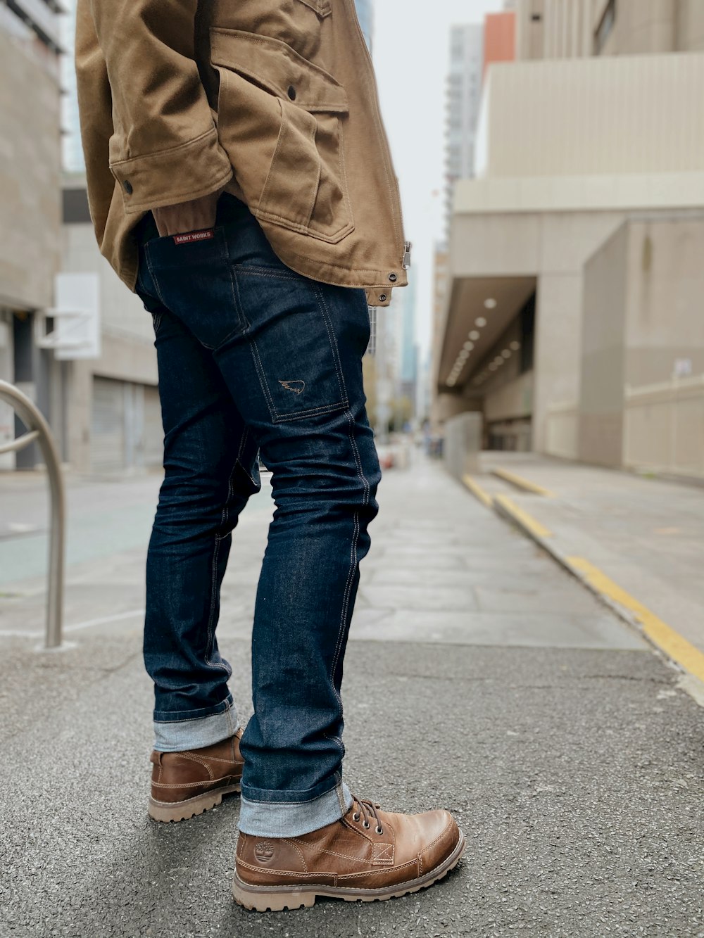 a man standing on a sidewalk with his foot on the ground