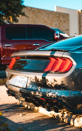 A sleek car parked in front of a modern Texas home on a sunny day.