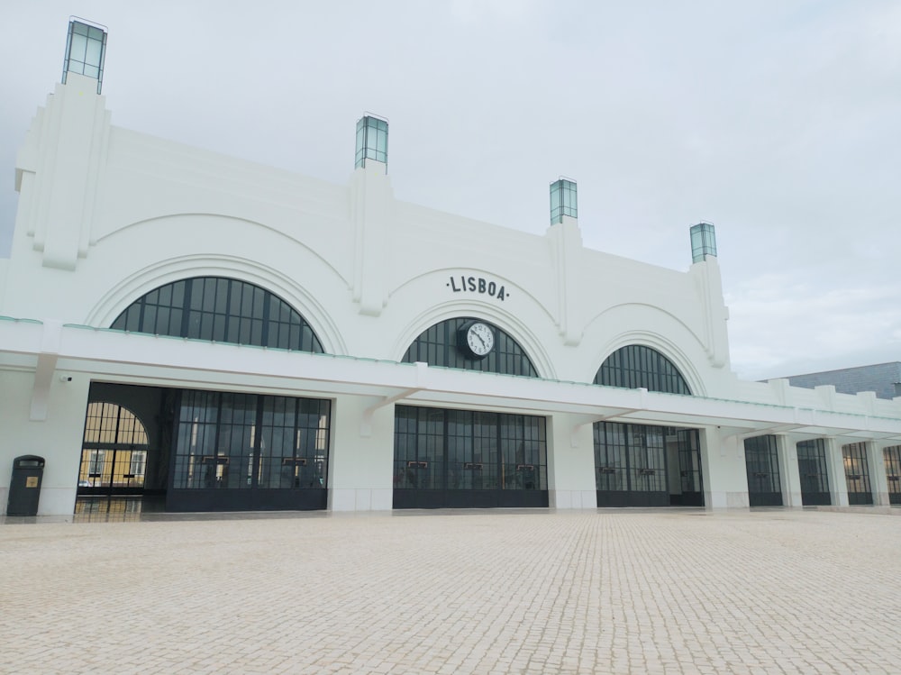 a large white building with a clock on the front of it