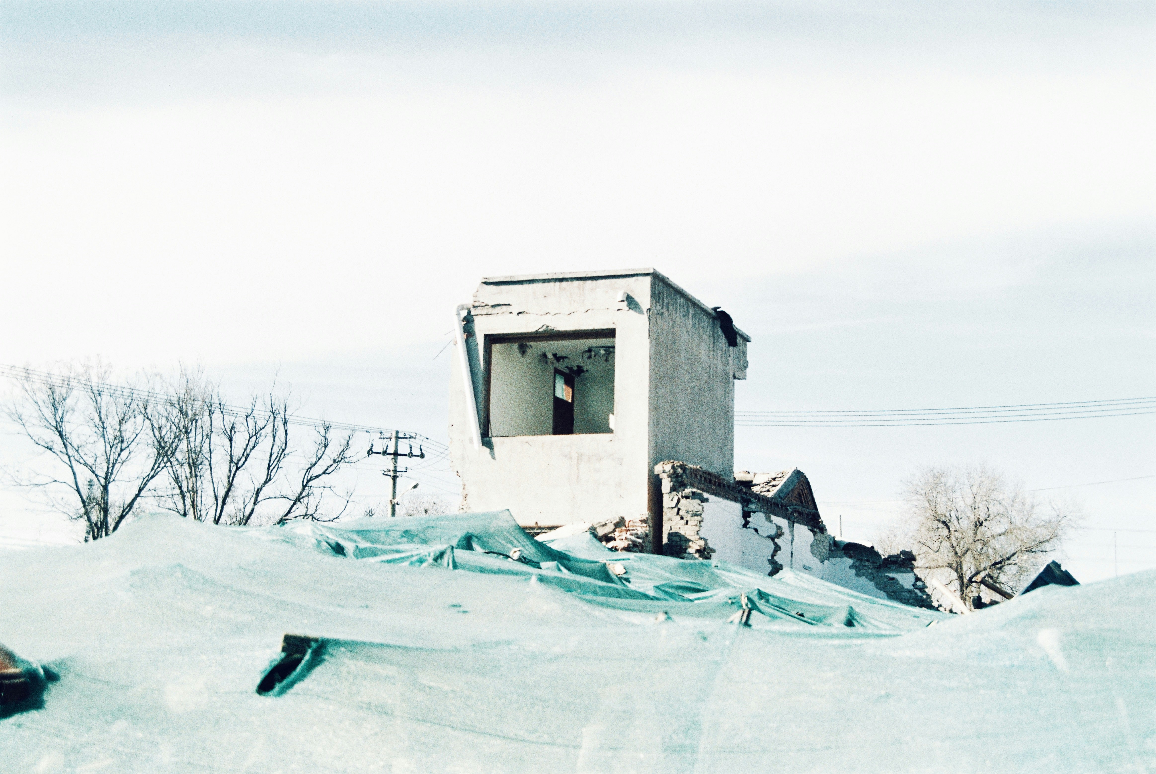 a man riding a snowboard down the side of a snow covered slope