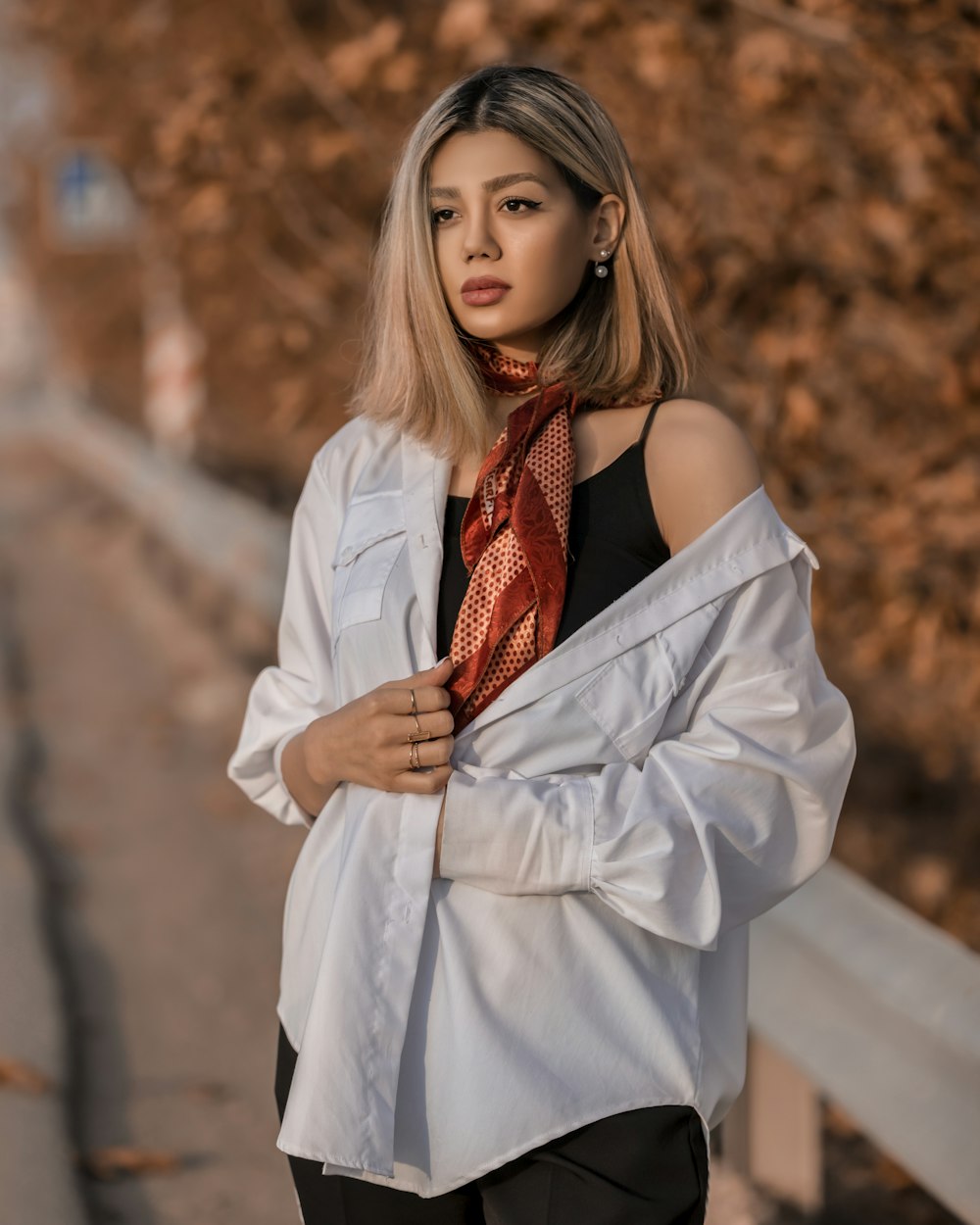 a woman wearing a white shirt and a red neck tie