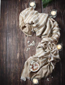 Delicate arrangement of natural plant extracts and crystals on a soft beige textile under golden light.