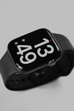 an apple watch with a black band and white numbers