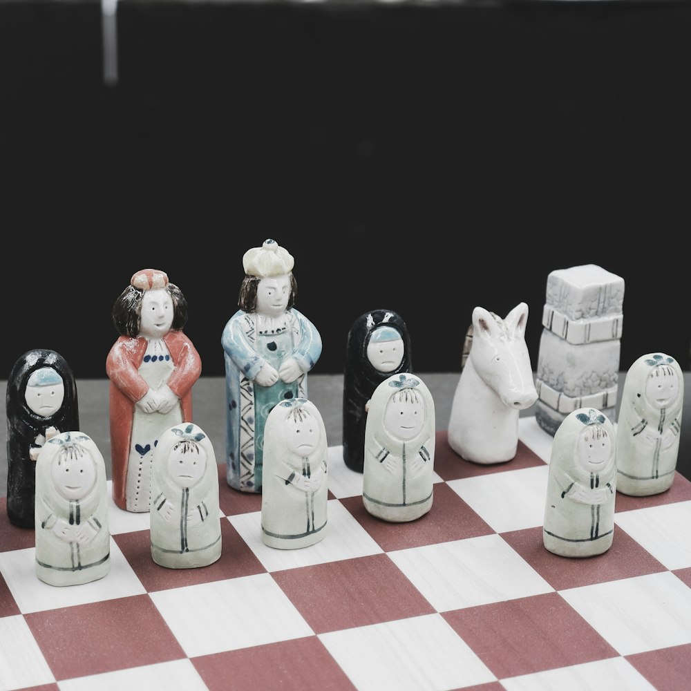 a chess board with a group of figurines on it
