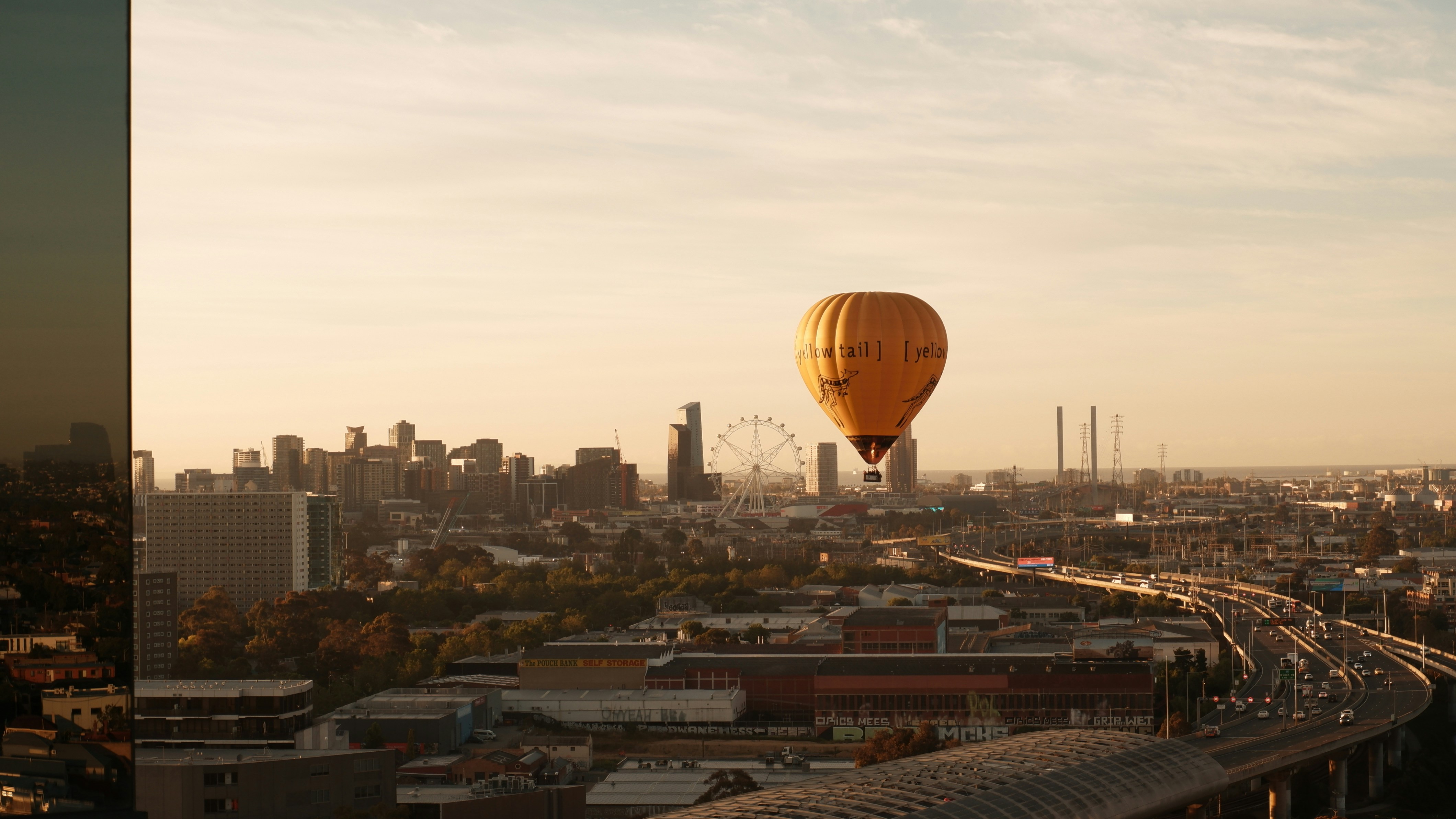 a hot air balloon flying over a city
