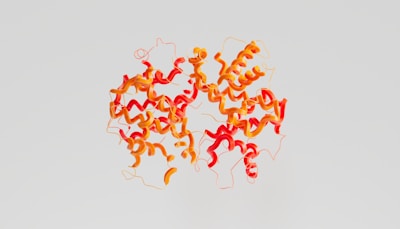 A complex, colorful molecular structure featuring a series of interconnected, swirling ribbons in red and orange hues against a light gray background. The ribbons curve and intertwine in a symmetrical pattern, resembling a detailed scientific illustration.