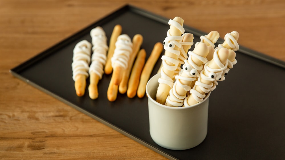 a black tray topped with cookies and pretzels