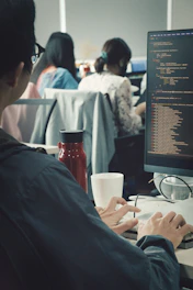 a man sitting at a desk working on a computer