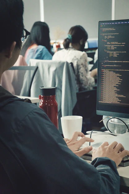 a man sitting at a desk working on a computer