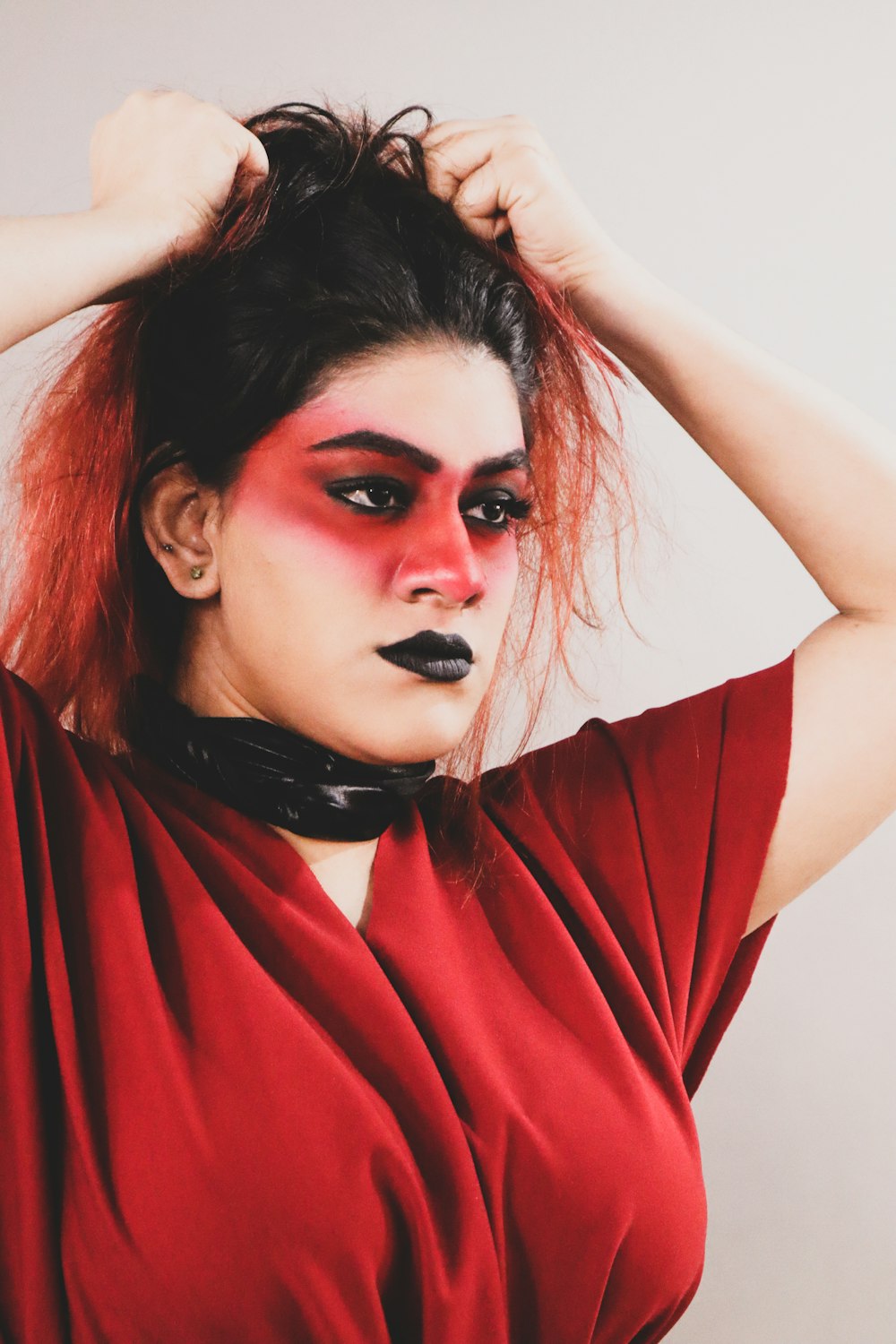a woman with red makeup and black lipstick