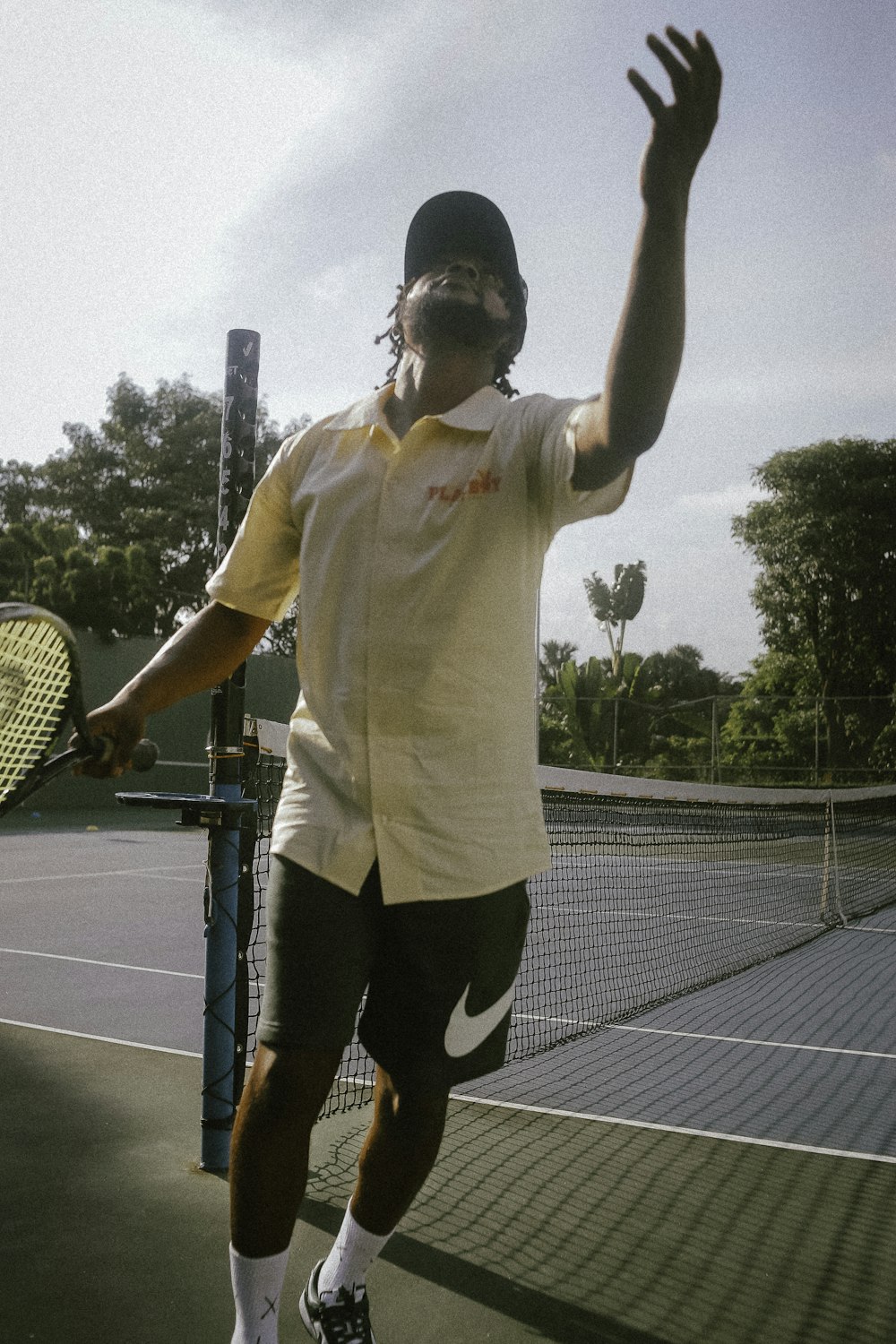 a man holding a tennis racquet on top of a tennis court