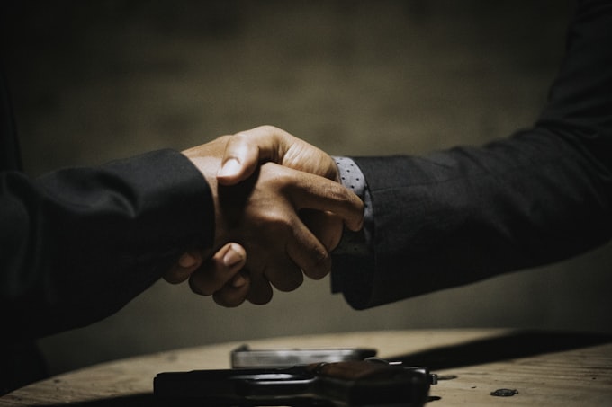 Two people shaking hands over an agreement