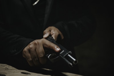 a man holding a gun in his right hand
