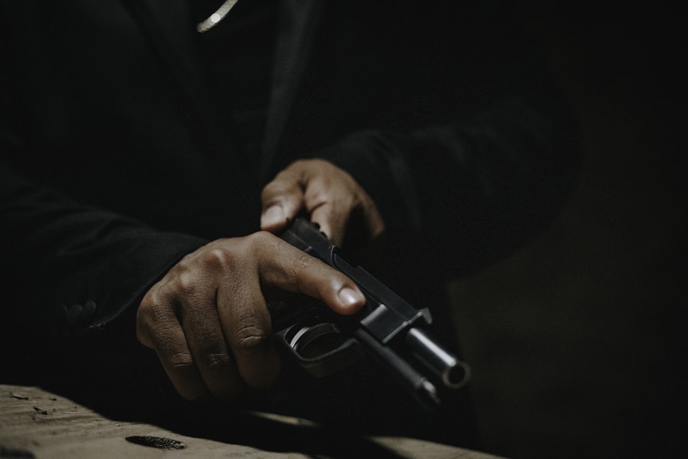 a man holding a gun in his right hand